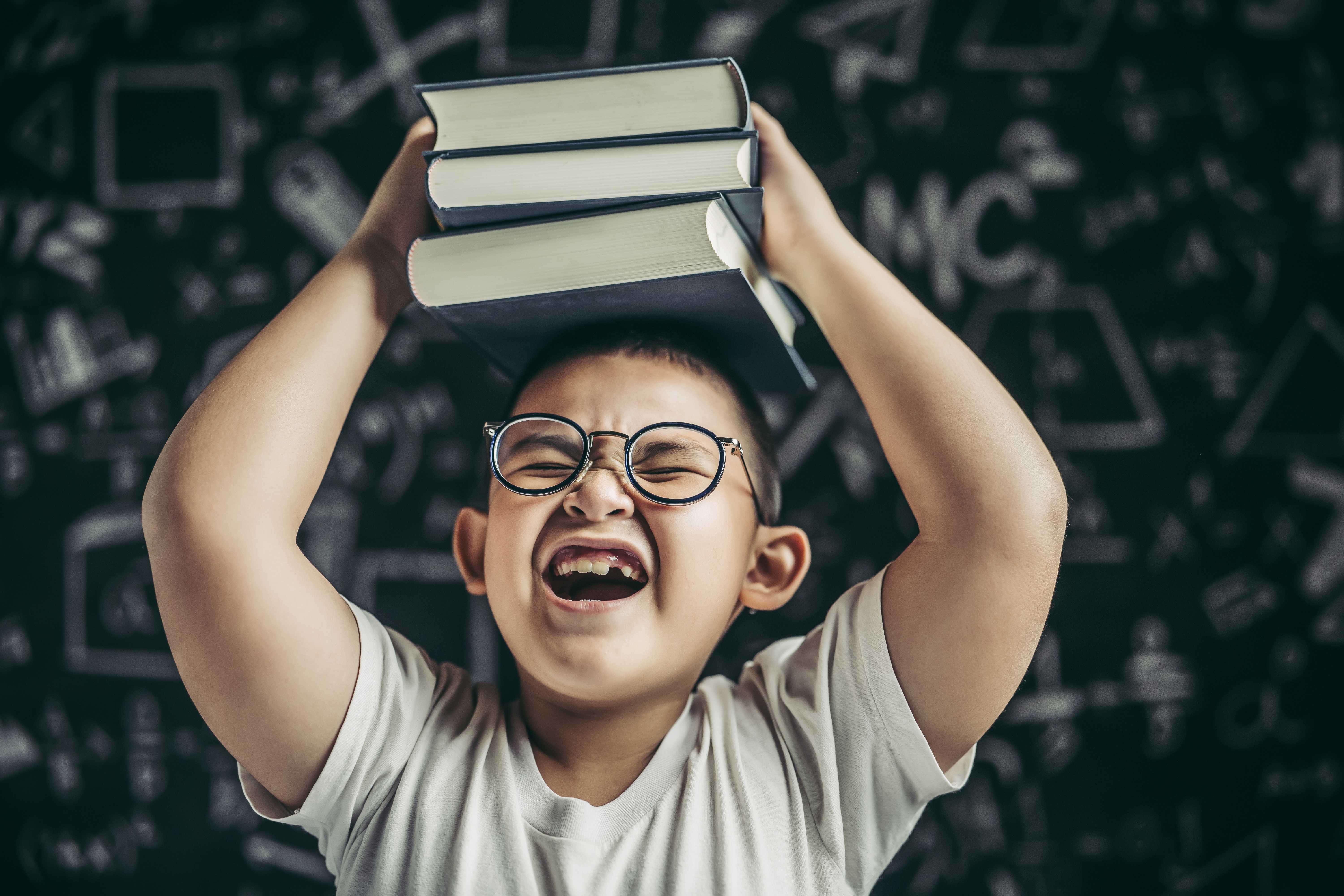 boy-with-glasses-studied-put-book-his-head-classroom.jpg